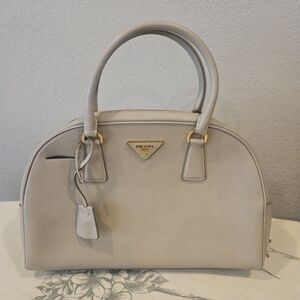 Prada Saffiano Bowler Bag Beige Top Handles Gold Hardware with lock & clochette.